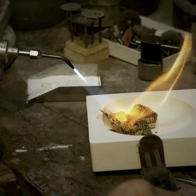 In the atelier: the flame on the bench, a ring under the file.